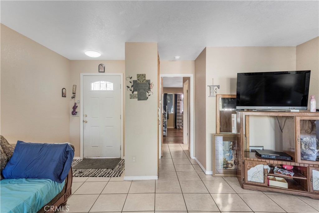 240 North 4th Street Shandon, CA 93461 - Photo 8 of 38 a living room with furniture and a flat screen tv