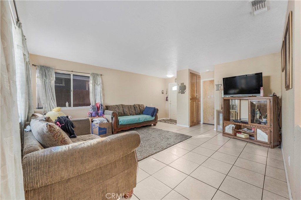 240 North 4th Street Shandon, CA 93461 - Photo 10 of 38 a living room with furniture and a flat screen tv