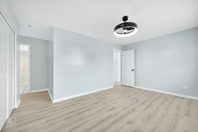 a bathroom with a toilet sink vanity tub and mirror