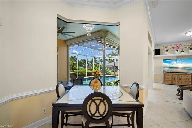 a kitchen with stainless steel appliances granite countertop a stove top oven a sink dishwasher a dining table and chairs with wooden floor