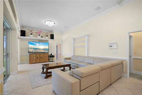 a kitchen with a sink a counter and chairs in it