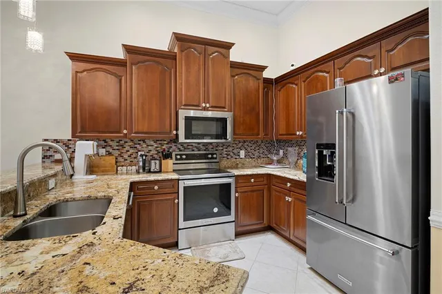 a kitchen with kitchen island granite countertop a table and chairs in it