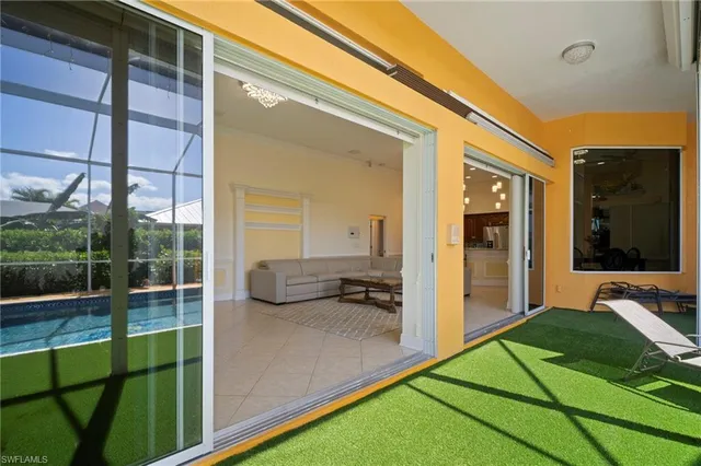 a dining room with furniture and a potted plant
