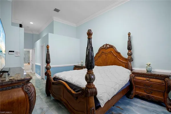 a bedroom with a bed and a flat tv screen on the dresser