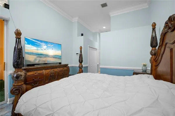 a bedroom with a bed and a dresser