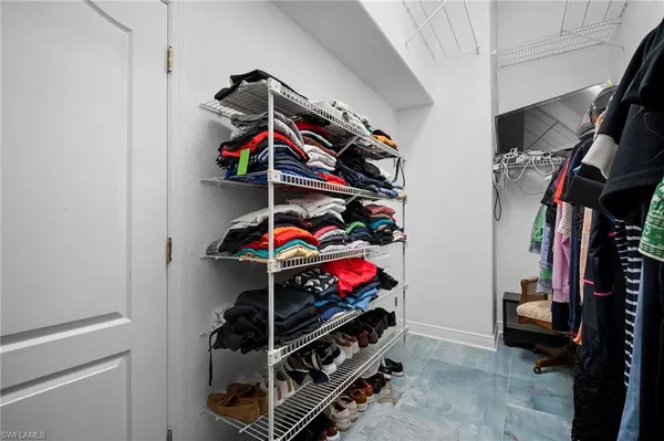a view of a hallway with a white walls and stairs