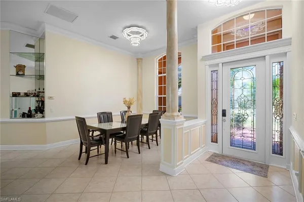 a view of a dining room with furniture and chandelier