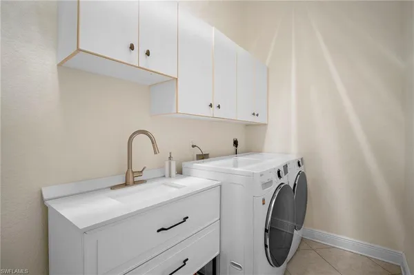 a spacious bathroom with a tub double sink and mirror