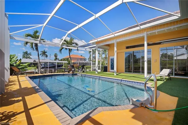 a view of a backyard with swimming pool