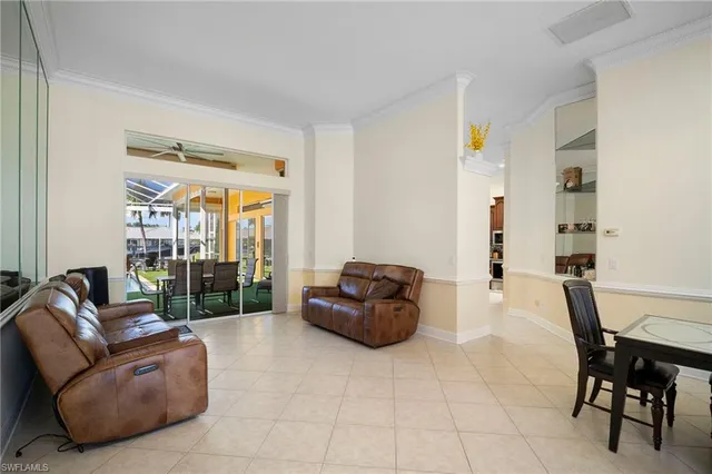 a living room with furniture and a floor to ceiling window