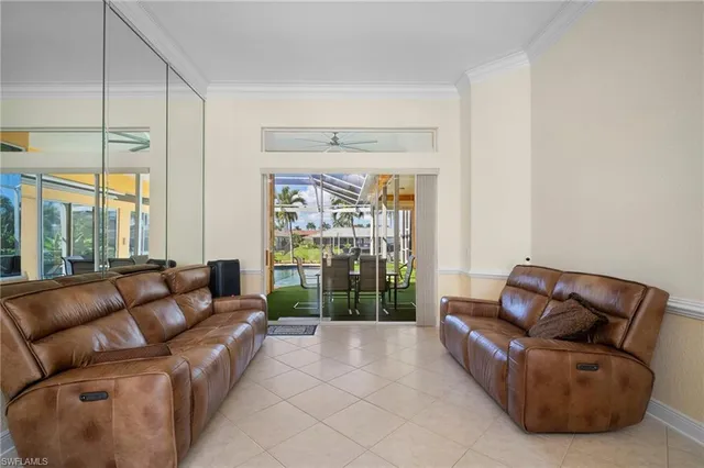 a living room with furniture and a floor to ceiling window