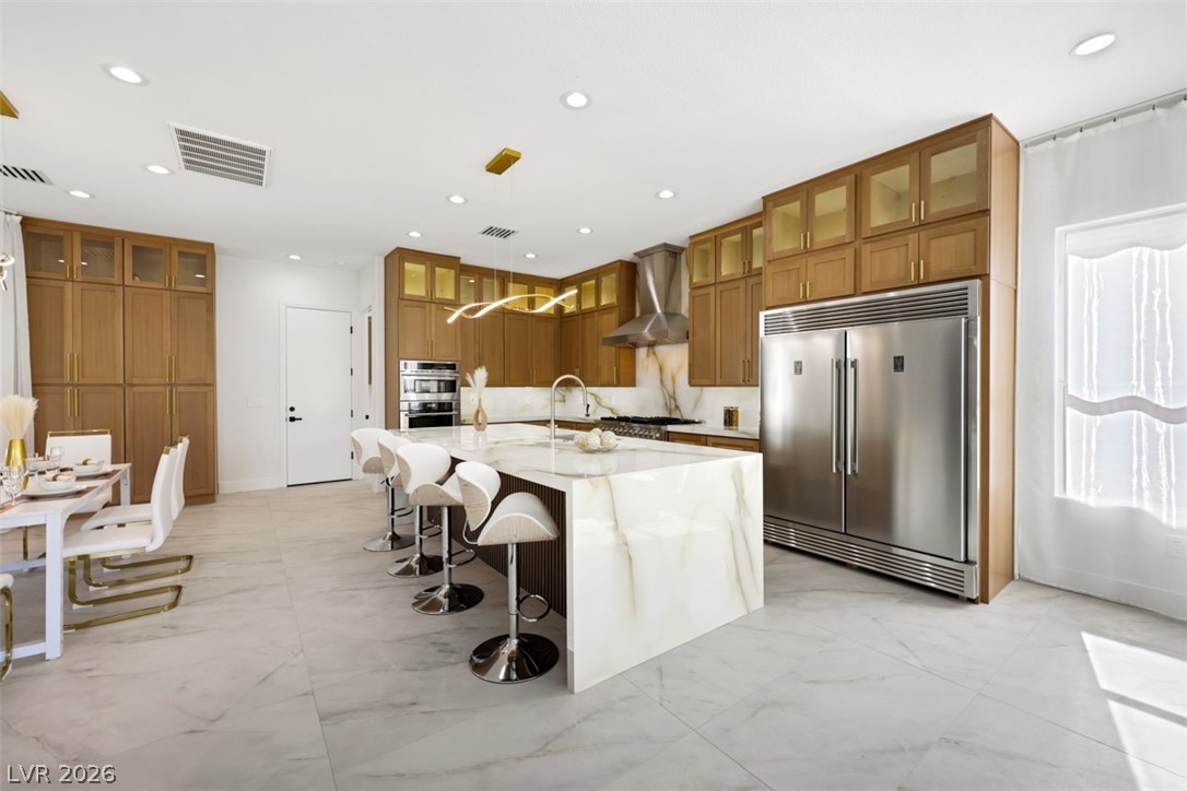 5015 Rivedro Street Las Vegas, NV 89135 - Photo 20 of 91 Culinary delights await in this bright kitchen, showcasing a spacious island, premium appliances, and ample cabinetry.