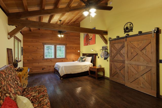 a bedroom with a bed and wooden floor