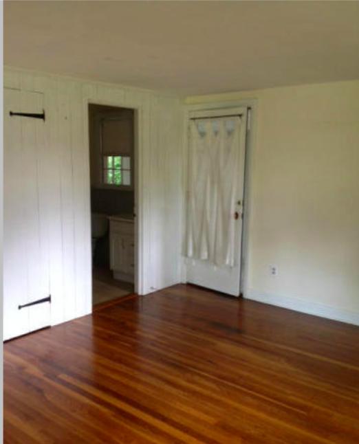 106 Woodland Road New Canaan, CT 06840 - Photo 4 of 10 a view of an empty room with wooden floor and a window