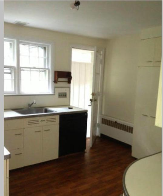 106 Woodland Road New Canaan, CT 06840 - Photo 6 of 10 a kitchen with granite countertop a stove a sink and a window