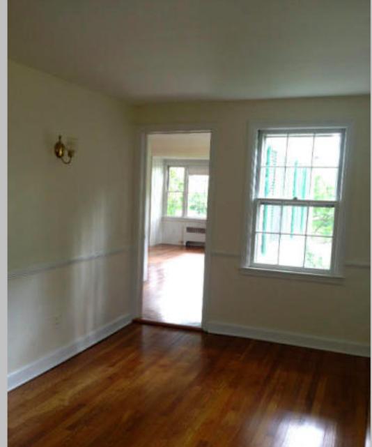 106 Woodland Road New Canaan, CT 06840 - Photo 7 of 10 an empty room with wooden floor and windows