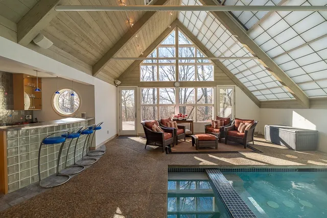 a living room with fireplace furniture and a large window