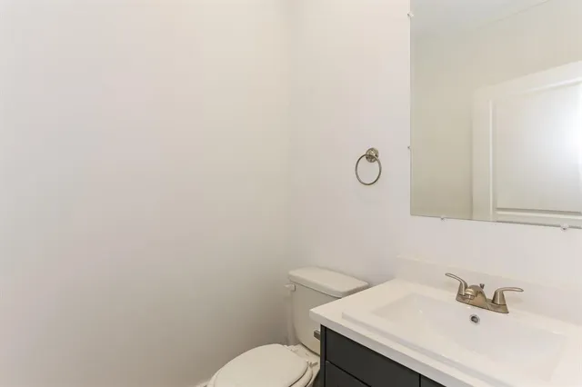 a bathroom with a sink mirror and toilet