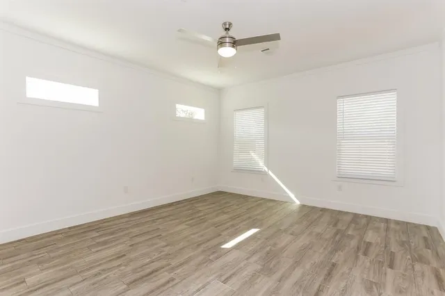 wooden floor in an empty room with a window