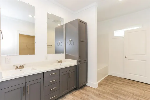 a bathroom with a double vanity sink mirror and double