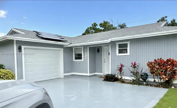 a front view of a house with garage
