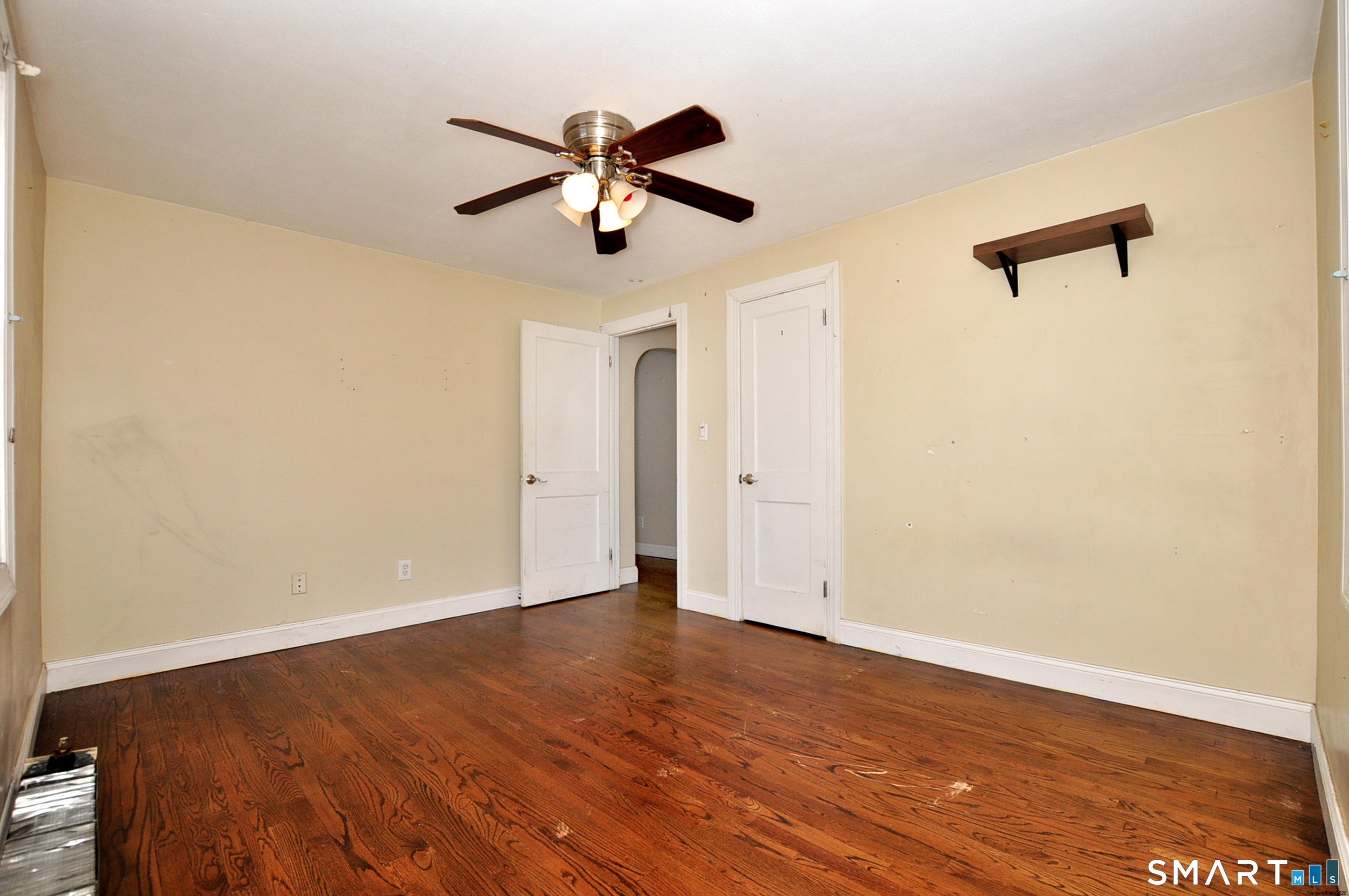 103 West Center Street Manchester, CT 06040 - Photo 24 of 29 an empty room with wooden floor chandelier fan and windows