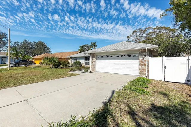 a view of a large white house with a yard