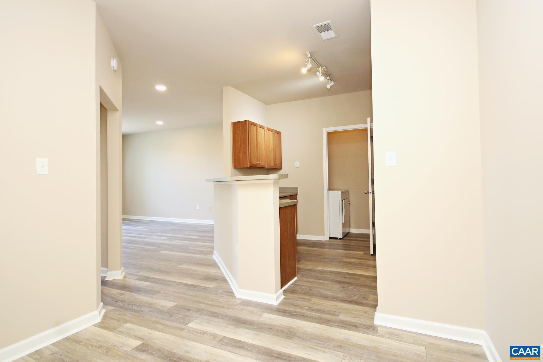 735 Walker Square, Unit 3D Charlottesville, VA 22903 - Photo 4 of 12 a view of a hallway with wooden floor and a hallway