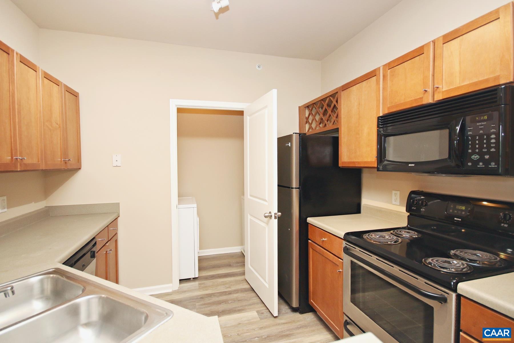 735 Walker Square, Unit 3D Charlottesville, VA 22903 - Photo 5 of 12 a kitchen with stainless steel appliances granite countertop a refrigerator stove and sink