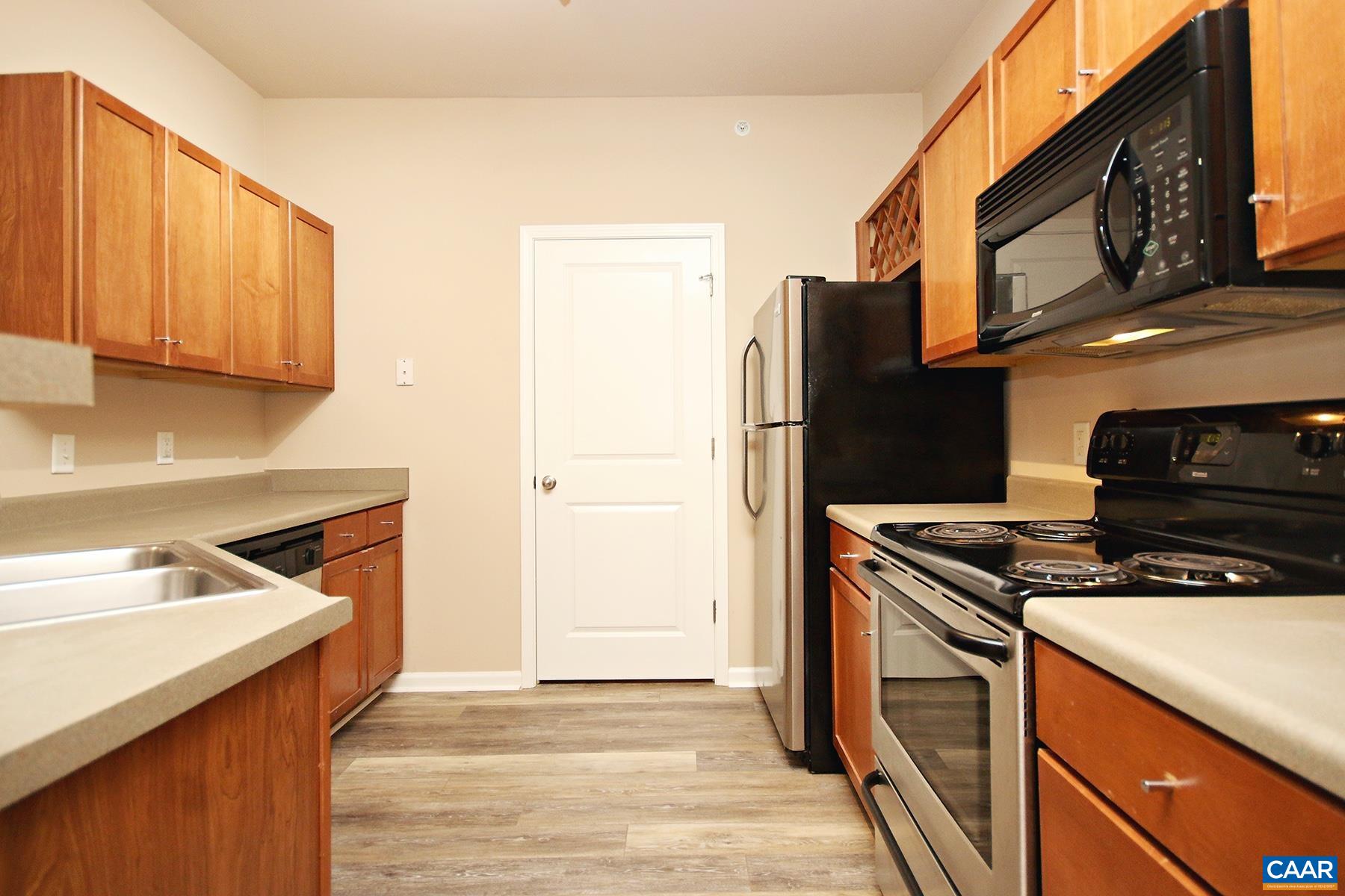 735 Walker Square, Unit 3D Charlottesville, VA 22903 - Photo 6 of 12 a kitchen with stainless steel appliances granite countertop a sink stove and refrigerator
