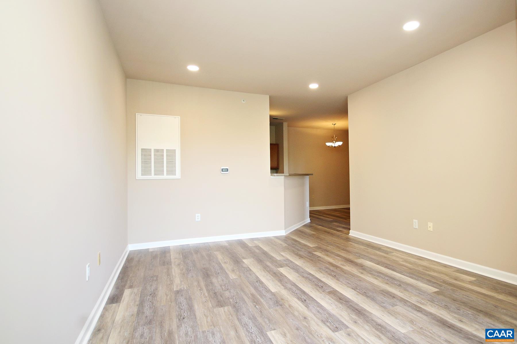 735 Walker Square, Unit 3D Charlottesville, VA 22903 - Photo 8 of 12 a view of hallway with a window and wooden floor