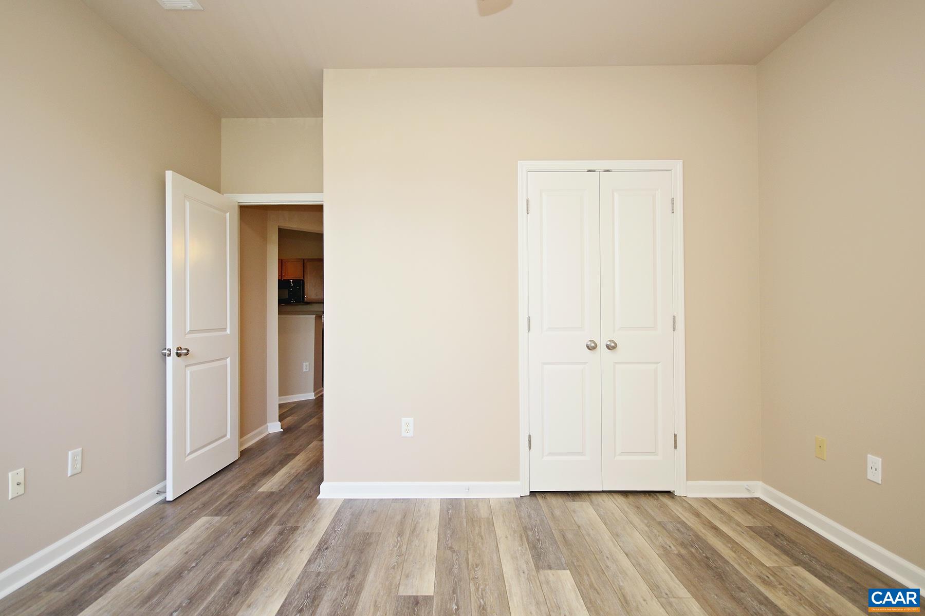 735 Walker Square, Unit 3D Charlottesville, VA 22903 - Photo 10 of 12 a view of an empty room and wooden floor