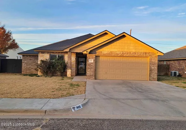 a view of a house with a yard and floor to ceiling window