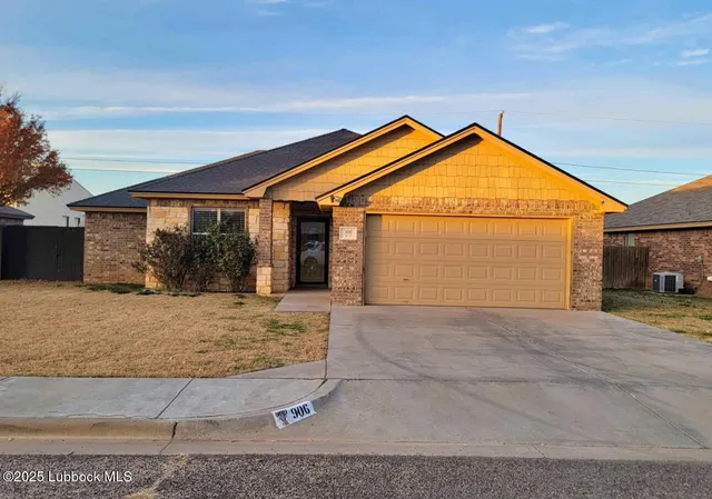 a view of a house with a yard and floor to ceiling window