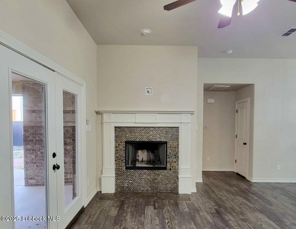 906 11th Street Wolfforth, TX 79382 - Photo 5 of 5 a living room with a fireplace and wooden floor