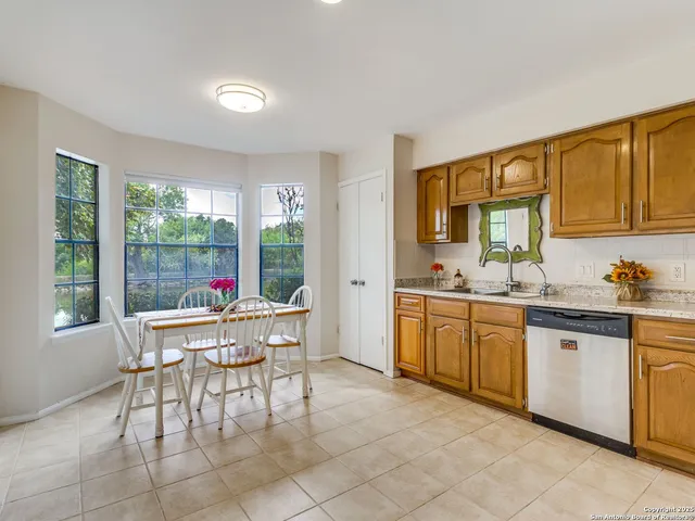 a living room with furniture a window and kitchen view