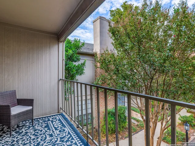 a view of a balcony with wooden floor