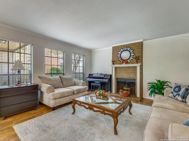 a living room with furniture and a fireplace