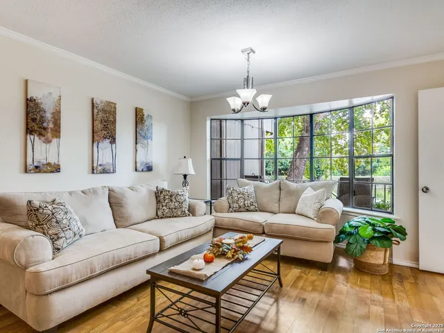 a living room with furniture and a chandelier