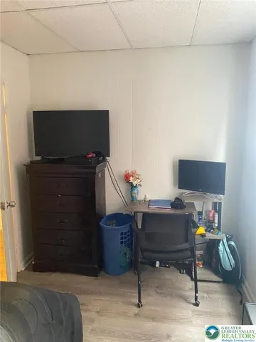 a livingroom with workspace and a couch