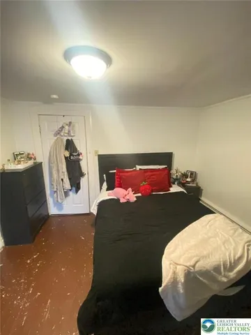 a bed sitting in a bedroom and dressers