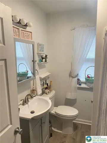 a bathroom with a toilet sink and mirror