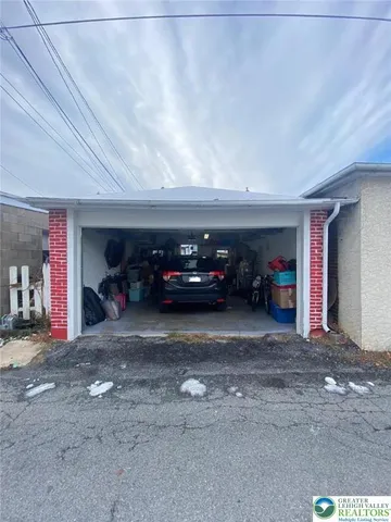 a front view of a house with a parking space