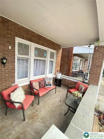 an outdoor living area with furniture and a rug