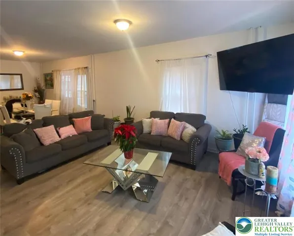 a living room with furniture and a flat screen tv