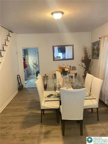 a living room with furniture a rug and a table