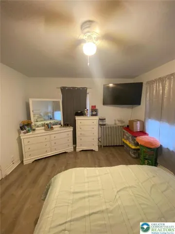 a bedroom with a bed and a view of kitchen