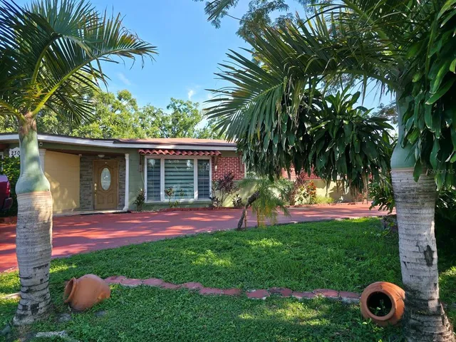 a view of backyard with table and chairs and potted plants