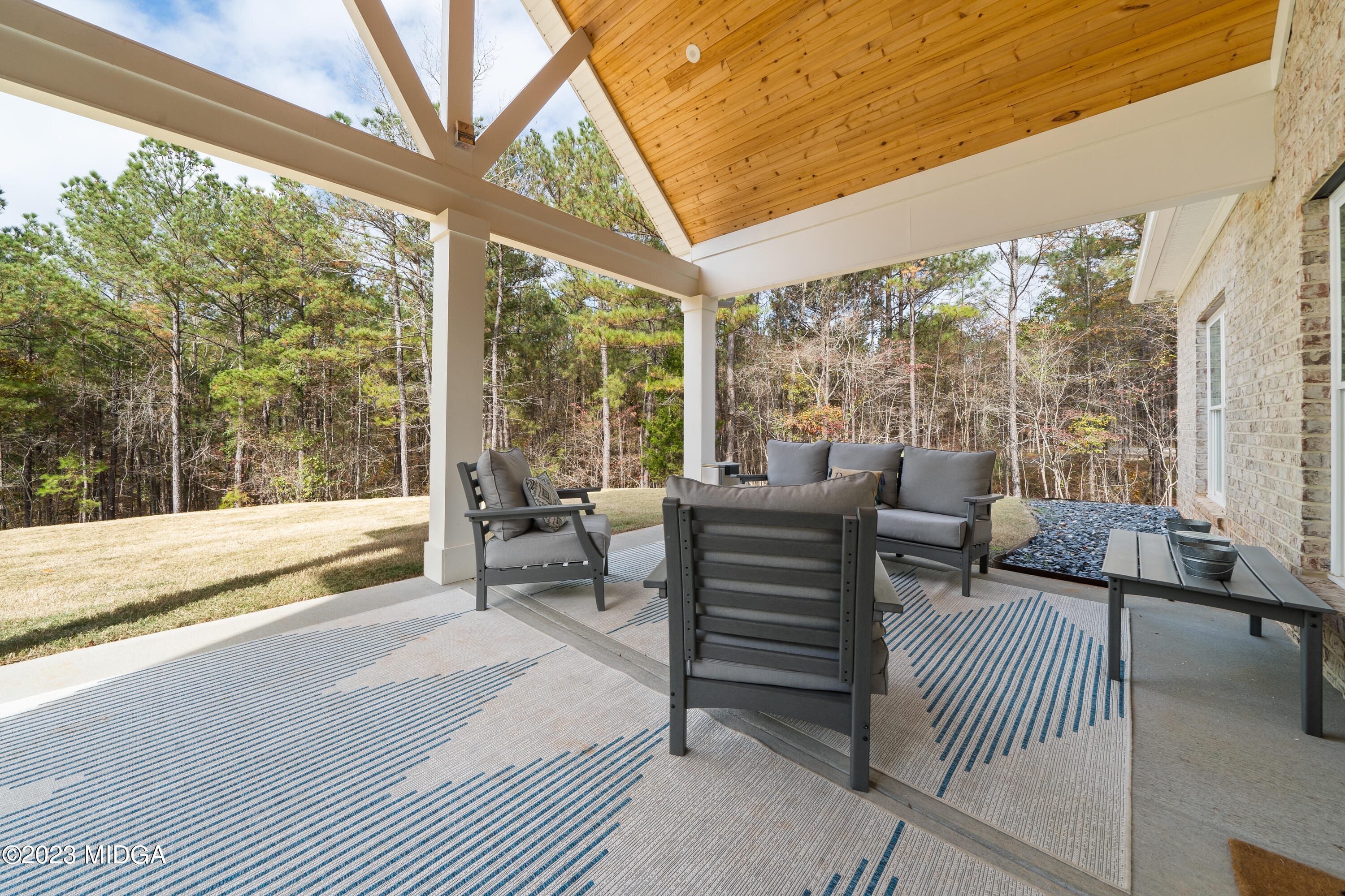 556 Pea Ridge Road Juliette, GA 31046 - Photo 13 of 42 a living room with furniture and a floor to ceiling window