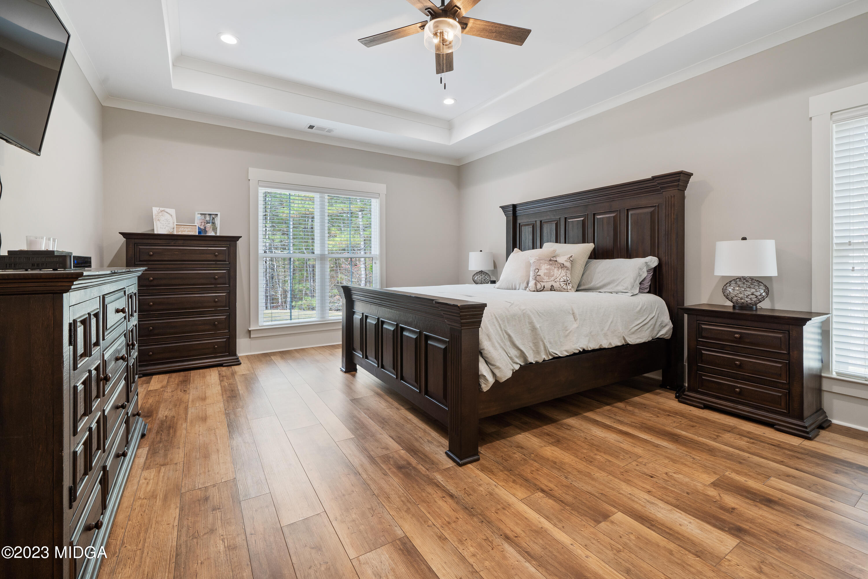 556 Pea Ridge Road Juliette, GA 31046 - Photo 16 of 42 a bedroom with a bed and a chandelier